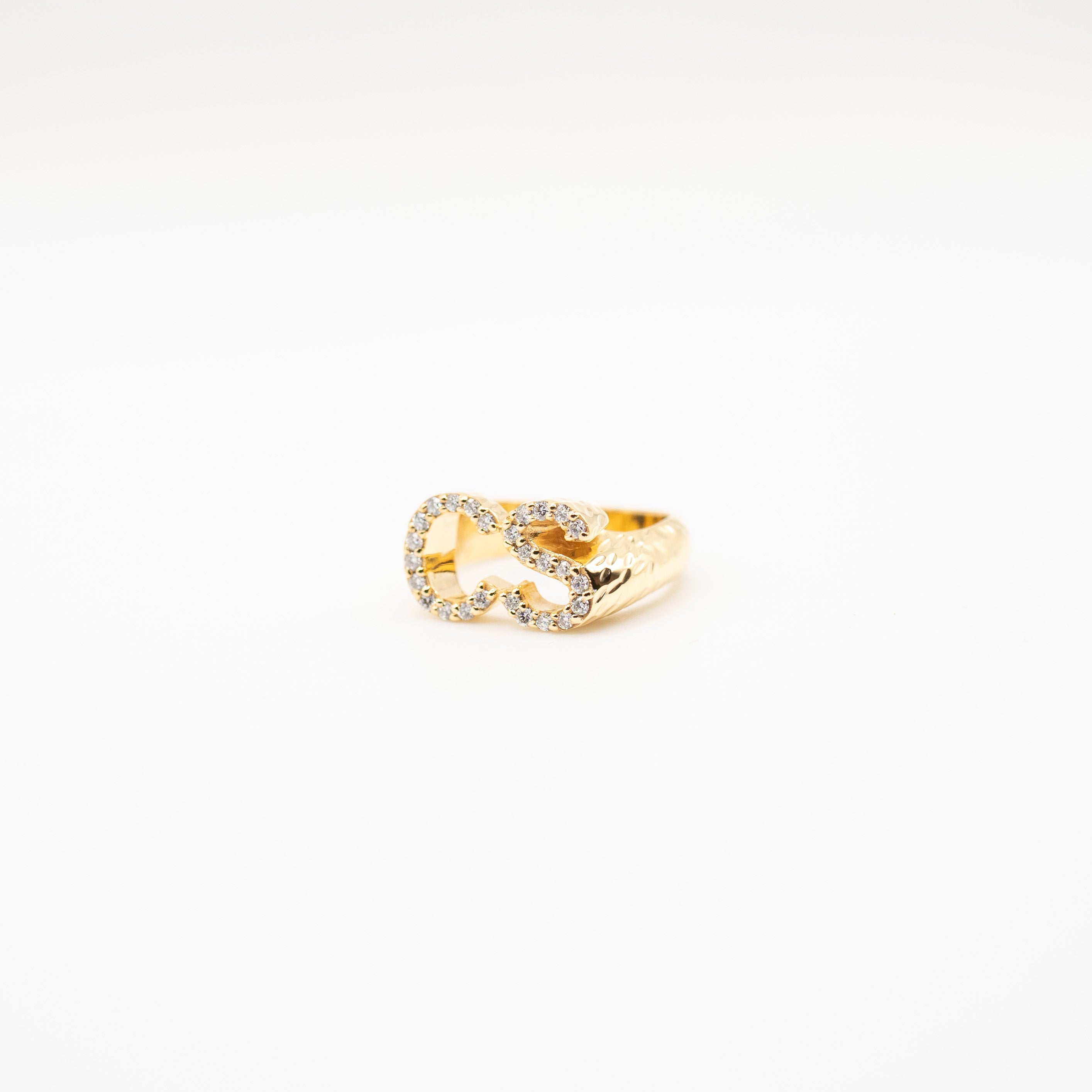 Gold ring with a diamond on a white background