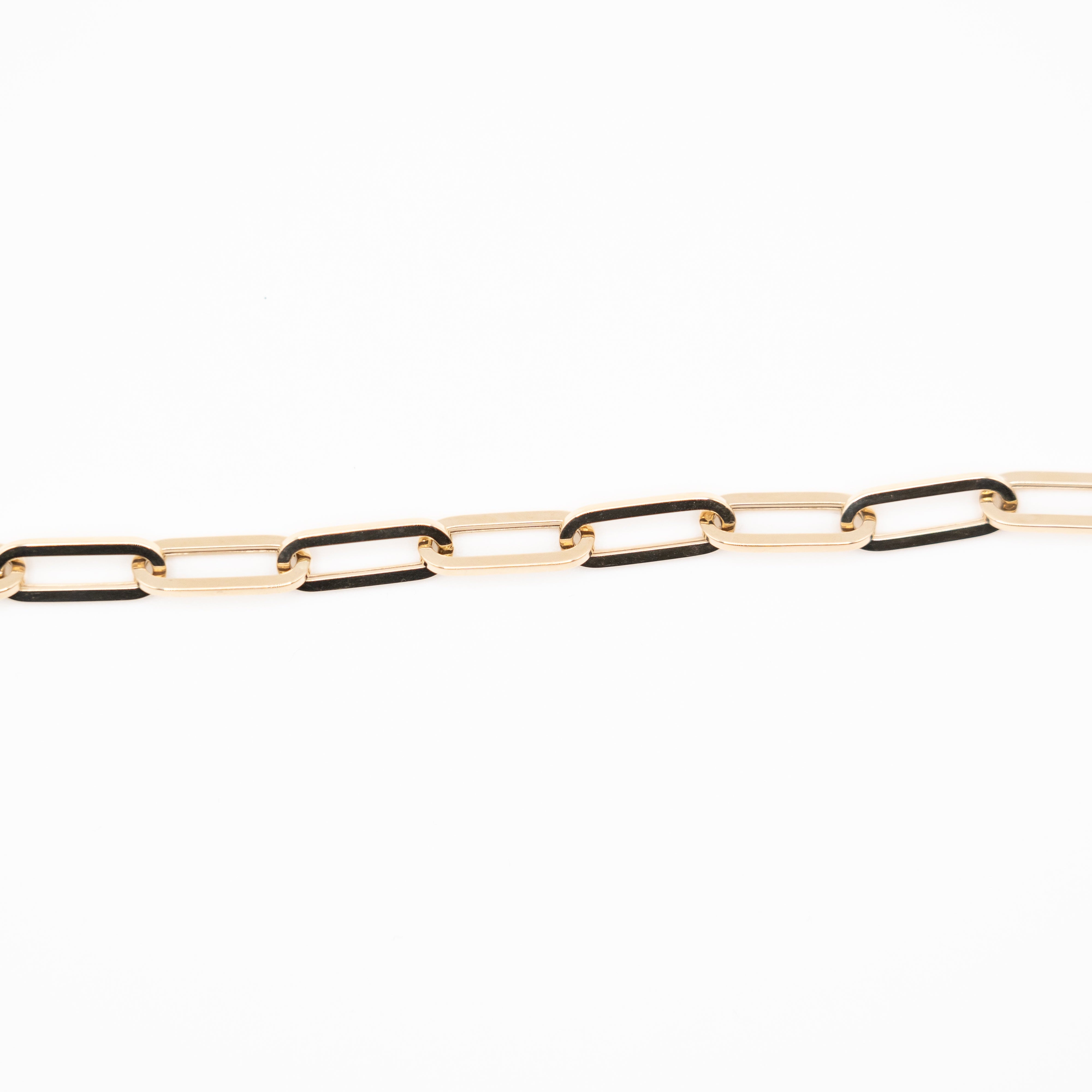 A close-up image of a 14k yellow gold bracelet with interlinked chain links.